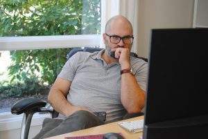 man thinking at computer